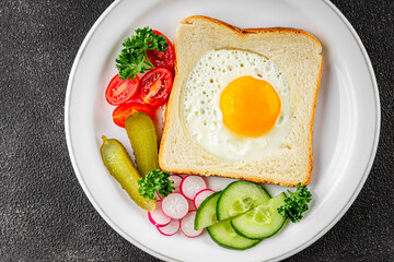 Fried gashouse eggs in bread egg in the basket delicious snack breakfast in a bowl fresh delicious gourmet food background on the table rustic food top view copy space