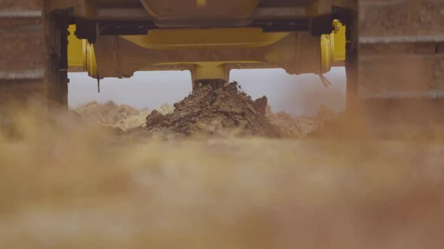 Close-up shot of a bulldozer moving soil on-site