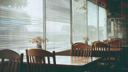 Empty restaurant interior with chairs stacked on tables, conveying quiet finality of closure. Abandoned cafe, business shutdown, last day of operation, deserted dining space concept.
