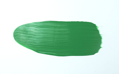 A smooth stroke of vibrant green paint spreads across white space
