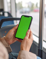 Young woman hold use green screen phone sitting in bus touch telephone public communication vertical smartphone adult finger chroma urban cellphone application digital scrolling slow motion