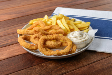 Delicious Fried Rings With Crispy Fries on a Plate