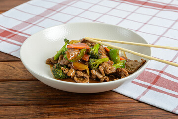 Savory Stir-Fried Beef With Colorful Vegetables Served in a Sleek Bowl at a Cozy Dining Table During a Relaxed Evening
