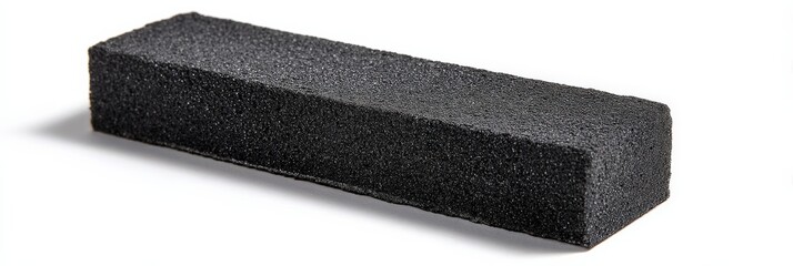 Black rectangular cleaning sponge on white background.