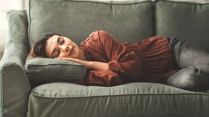 Young woman relax rest on sofa in living room