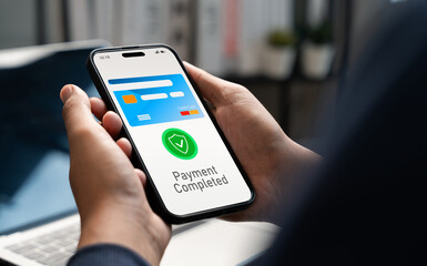 User confirms mobile payment on smartphone with a completed transaction message. Virtual credit card, Fintech, Digital wallet, E-commerce convenience, Online banking, Technology in modern finance.