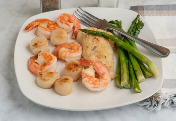 baked haddock with  asparagus  shrimp and scallops