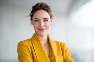 Confident businesswoman in yellow blazer smiling in modern office environment