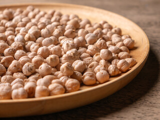 Raw Chickpeas on a rustic wooden table. Dry chickpea background close up. Chickpea legumes seed background.