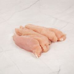 Fototapeta premium Fresh raw chicken breast strips on a marble surface clean and healthy – High Resolution Raw Meat Image for Food Industry or Food Packaging