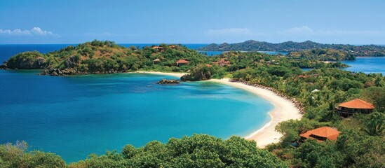 Secluded tropical beach cove with turquoise water, lush greenery, and luxury villas.