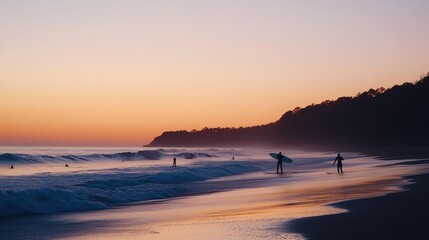 Beach sunset with surfers on shore. Waves breaking gently, peaceful twilight.
