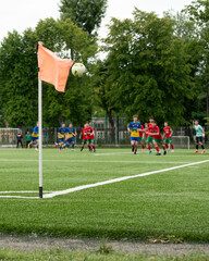Players in colorful uniforms are engaged in an intense soccer match, preparing for a corner kick...