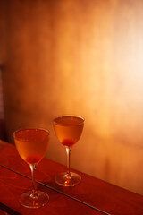 Classic cocktail glass with cherry in a nightclub bar counter, close-up