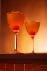 Classic cocktail glass with cherry in a nightclub bar counter, close-up