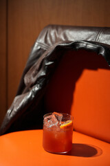 Classic orange cocktail with ice cubes served in a rocks glass nightclub restaurant, close-up