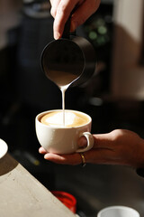 Pouring Milk into Coffee for Latte Art, close-up