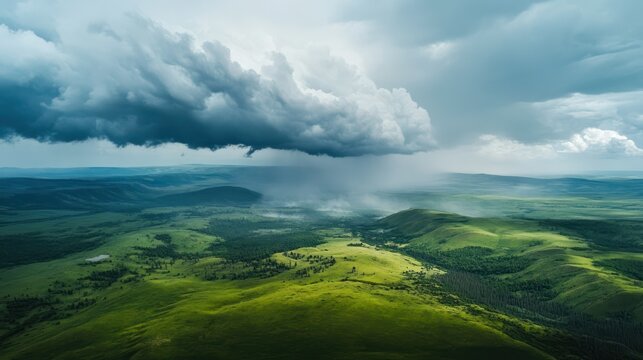 A landscape photo of rolling green hills under a dramatic storm cloud.