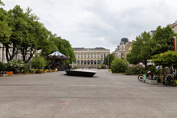 Saint Etienne in France, city center, town hall with forecourt surrounded by shops and cafes in spring © A.Freund