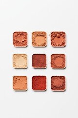 Colorful makeup powder samples arranged in grid on white background