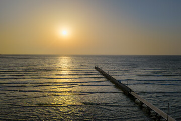 Obraz premium Sunset View of Haraoka Pier with Visitors Enjoying the Ocean, Chiba, Japan