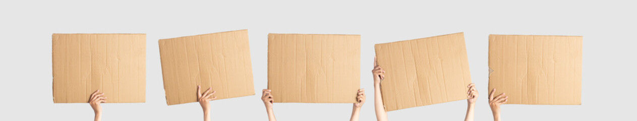 Posters of cardboard in his hands. Isolated on white. Set. Copy space. Hand-held cardboard cutout on white background