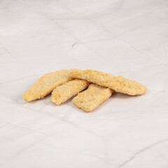 Breaded fish sticks arrangement isolated on a clean marble surface ready to cook – High Resolution Raw Meat Image for Food Industry or Food Packaging