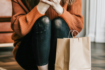 Person experiencing an anxiety attack, clutching their chest and breathing into a paper bag for relief
