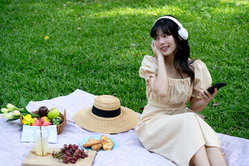 smiling young woman picnic  in a white dress a vision of bridal beauty and happiness  sits with headphone