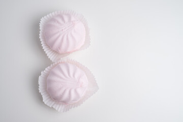 Pink marshmallow - sweet dessert close-up on a light background.