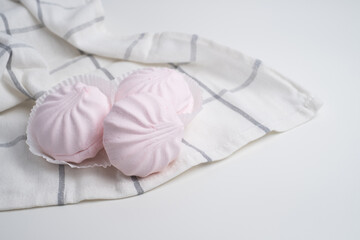 Pink marshmallow - sweet dessert close-up on a light background.