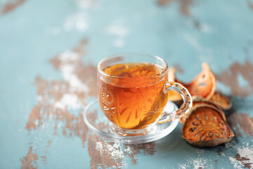 Thai healing matoom tea made of dried bael fruit slices, also known as wood apple, in transparent...