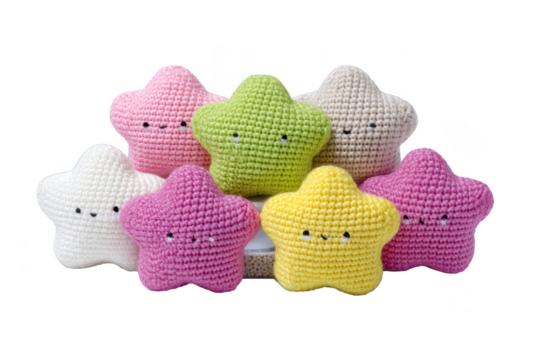 A collection of colorful crocheted star shaped toys with smiling faces, featuring pink, green, yellow, and white hues, arranged in cheerful display