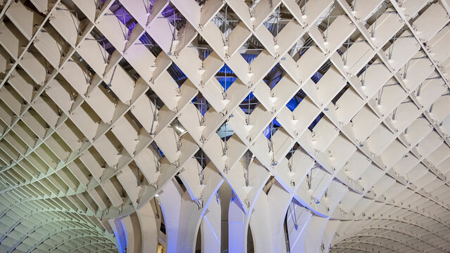 Setas de Sevilla, La Encarnacion square, Seville, Andalusia, Spain - June 25, 2019: close-up detailed shot at night with colorful light over the wooden structure known as Metropol Parasol or Las Setas
