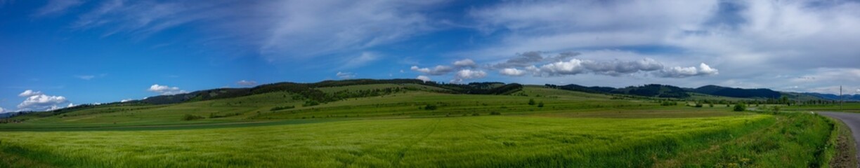 Obraz premium Panoramic view, agricultural fields near asphalt road at sunset in Transylvania, Romania.