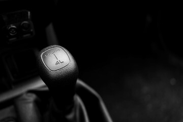 High , 4x4 low shifting knob in old german car in black and white, space for text.