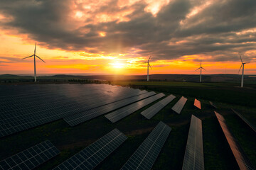 Fototapeta premium Green energy reduces pollution and keeps the environment clean and sustainable. Wind turbines and solar parks are two adopted renewable energy technologies used to generate electricity sustainably.