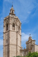 Valencia Cathedral and Miguelete Tower (Micalet) from Plaza de la Reina, Spain. A standing Gothic masterpiece, framed by the lively atmosphere of one of Valencia most emblematic squares.