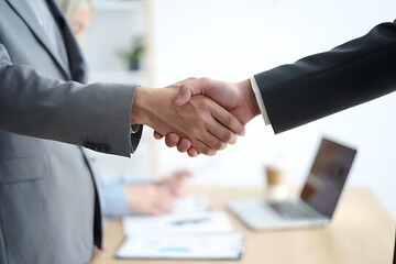 Businesspeople handshaking and sealing a deal in a professional office environment