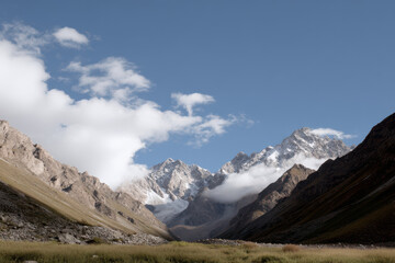 breathtaking view of pik tkhachi under clear blue morning sky with soft clouds drifting by
