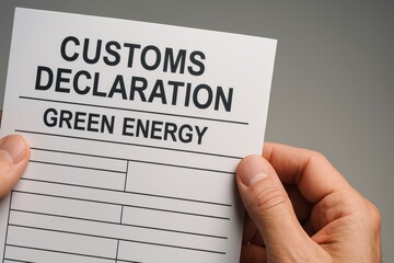 Customs Declaration Form for Green Energy with Hands Holding Blank Document