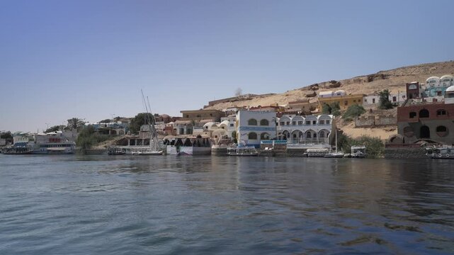View of colourful Nubian village from small boat on the Nile in daytime, Nagaa Suhayl Gharb, Aswan, Egypt, North Africa, Africa