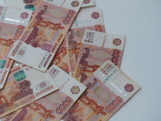 Russian ruble banknotes on white background. Close-up of various denominations with design details...