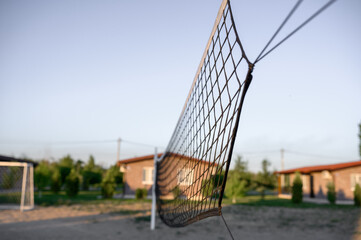 volleyball net stretched across a beach volleyball court