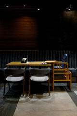 Restaurant interior with wooden table, chairs and children's chair