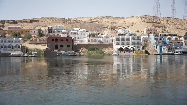 View of colourful Nubian village from small boat on the Nile in daytime, Nagaa Suhayl Gharb, Aswan, Egypt, North Africa, Africa