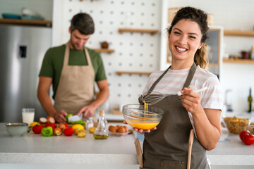 Professional personal chef cook in customer's private kitchen, giving a cooking lesson to people