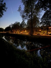 Fototapeta premium Picturesque view of canal and city street at night