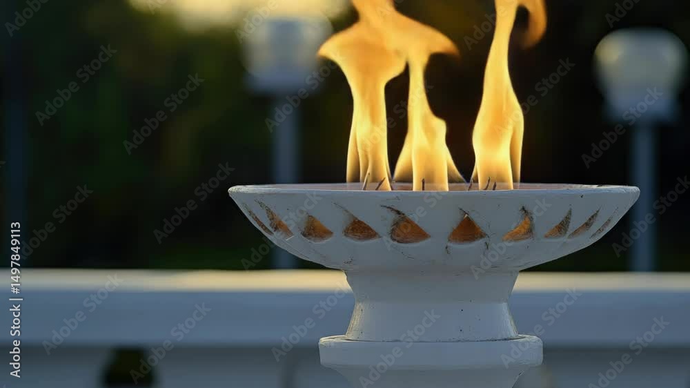 Poster a white ceramic bowl with a small fire burning inside, ideal for use as a decorative element or in a