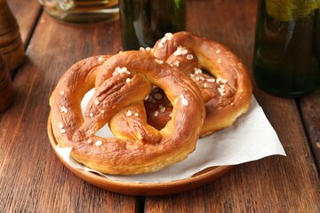 Tasty salted pretzels on wooden table, closeup